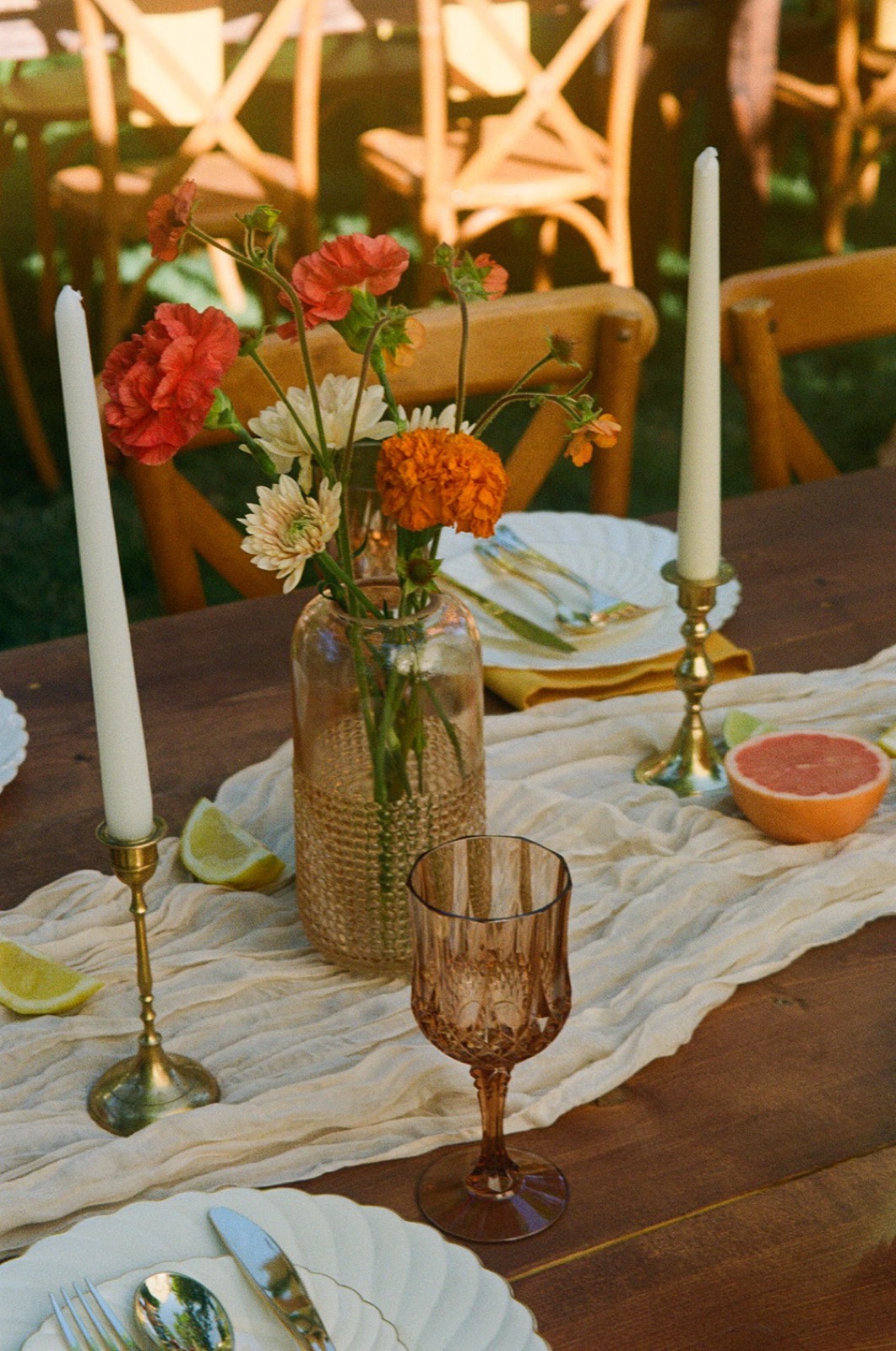 Backyard table with marigolds, tapers and citrus