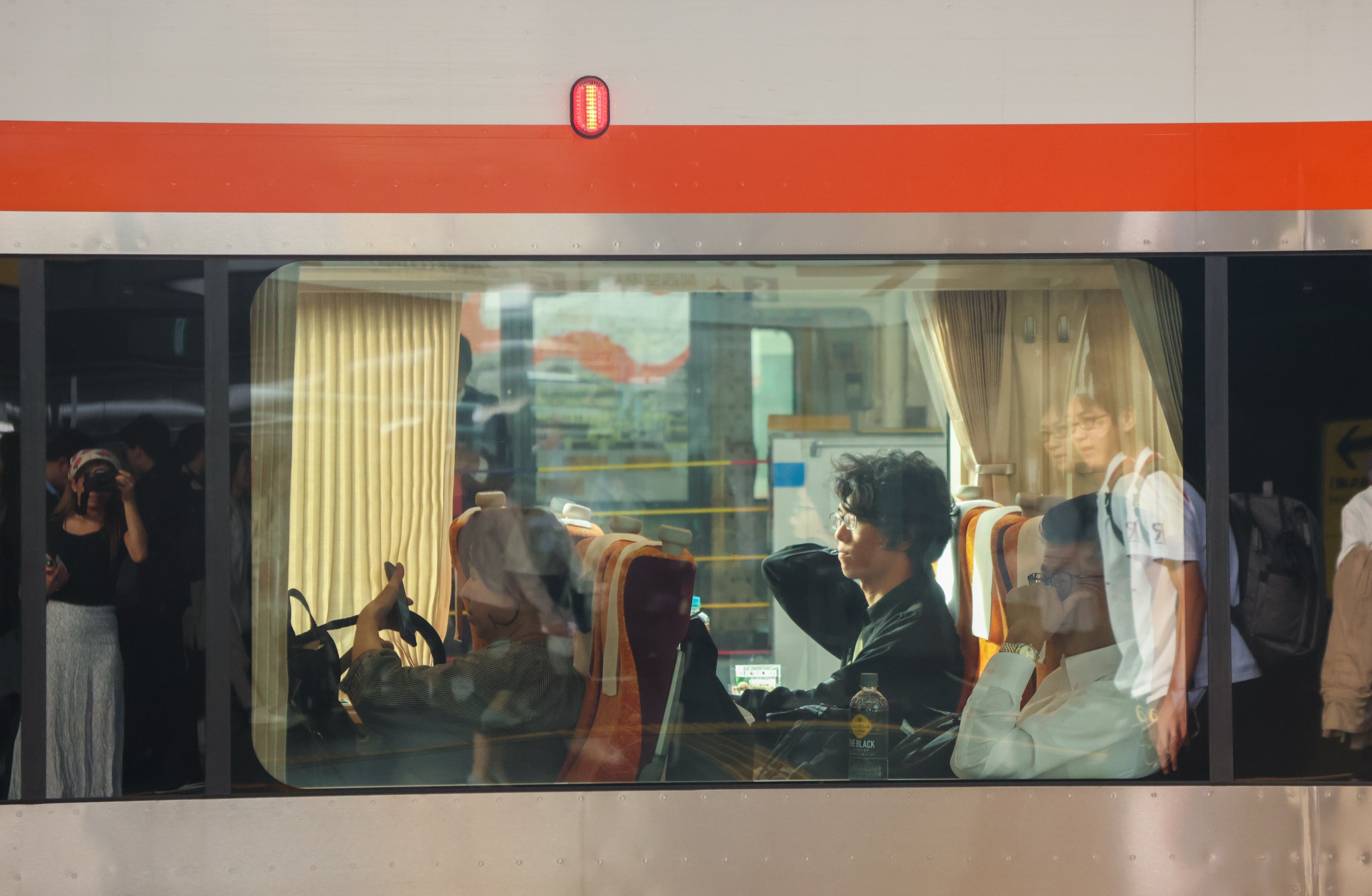Japan — a passenger framed in a train window