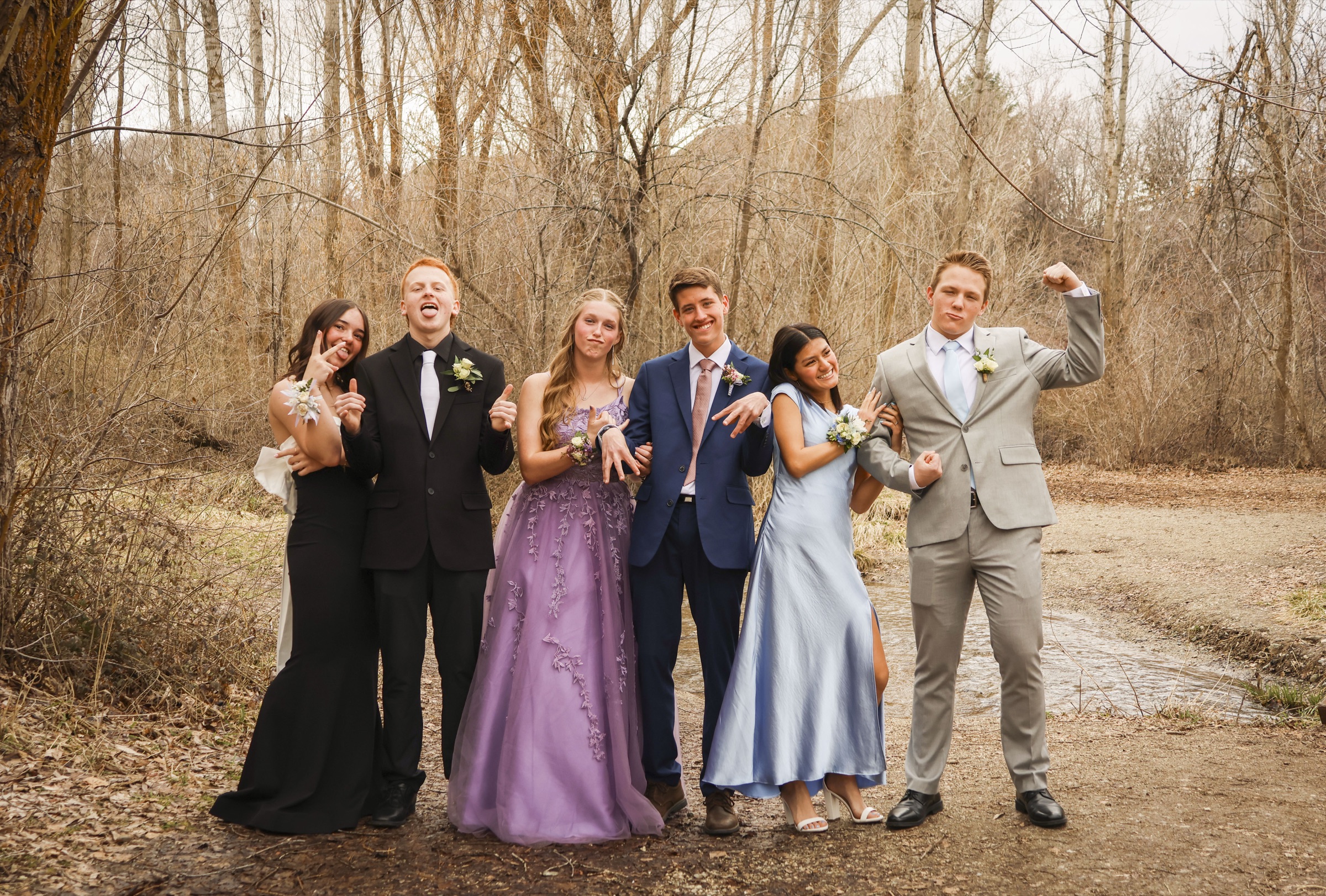 Kiara's prom group on a wooded trail