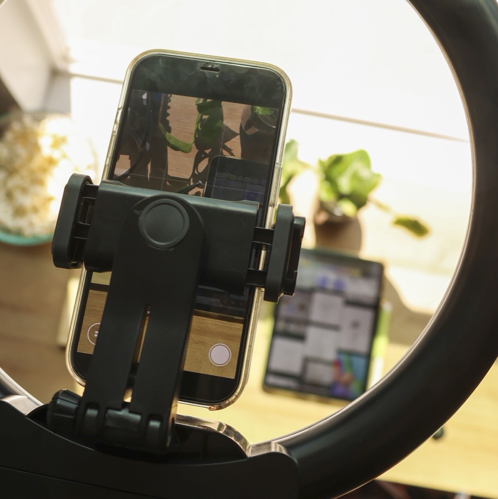 UGC & Content — a phone mounted on a ring light, filming a product